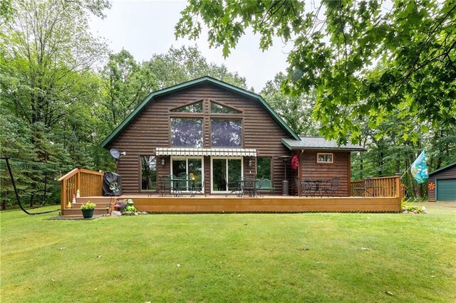 N1071 Ranch Rd, Holcombe, WI 54745 - rear view of property featuring faux log siding, a lawn, a gambrel roof, and a wooden deck