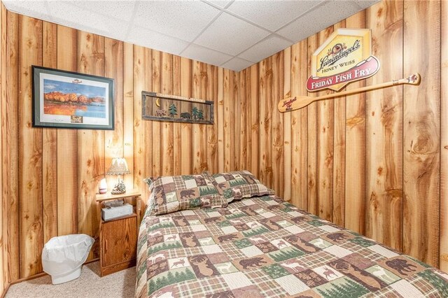 N1071 Ranch Rd, Holcombe, WI 54745 - bedroom featuring a drop ceiling, carpet, and wooden walls