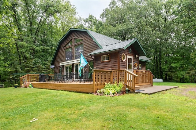 N1071 Ranch Rd, Holcombe, WI 54745 - back of house with a shingled roof, a wooden deck, and a yard
