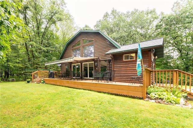 N1071 Ranch Rd, Holcombe, WI 54745 - back of property with a wooden deck, a gambrel roof, and a lawn