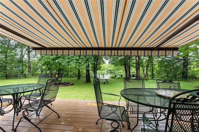 N1071 Ranch Rd, Holcombe, WI 54745 - deck with outdoor dining area, a water view, and a yard
