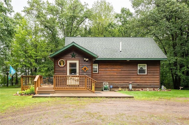 N1071 Ranch Rd, Holcombe, WI 54745 - back of property featuring roof with shingles, a deck, a yard, and a patio area