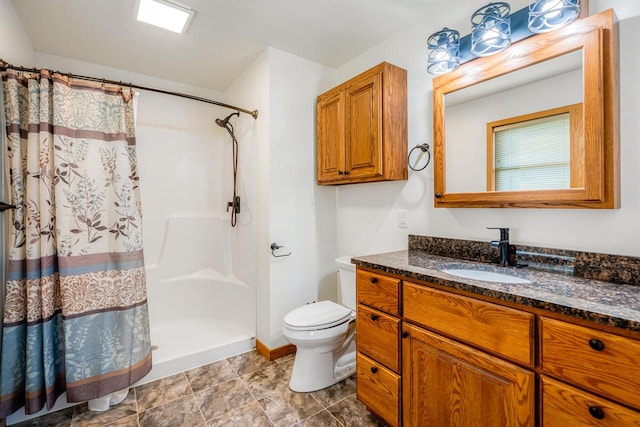 bathroom featuring vanity, toilet, and curtained shower