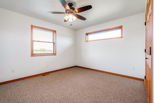 empty room featuring carpet and ceiling fan