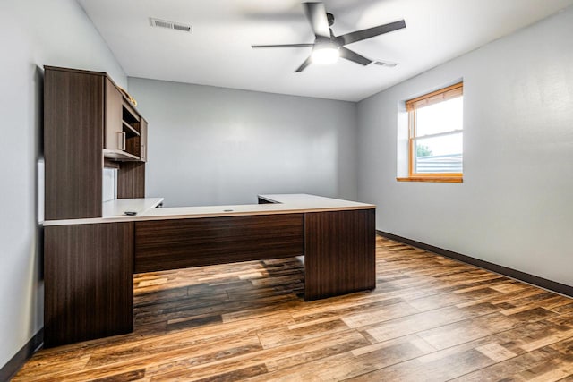 unfurnished office featuring light hardwood / wood-style flooring and ceiling fan