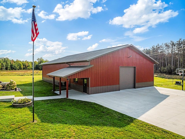 view of outbuilding with a garage and a lawn