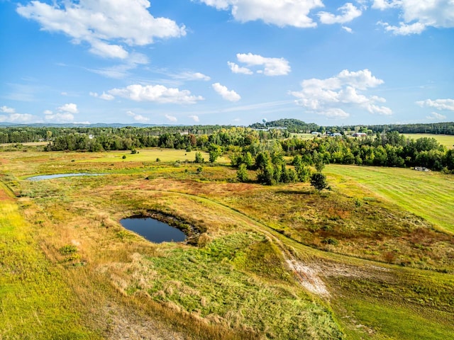 drone / aerial view featuring a water view and a rural view