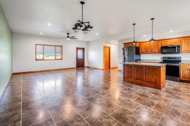 kitchen with a center island, ceiling fan, black appliances, and pendant lighting