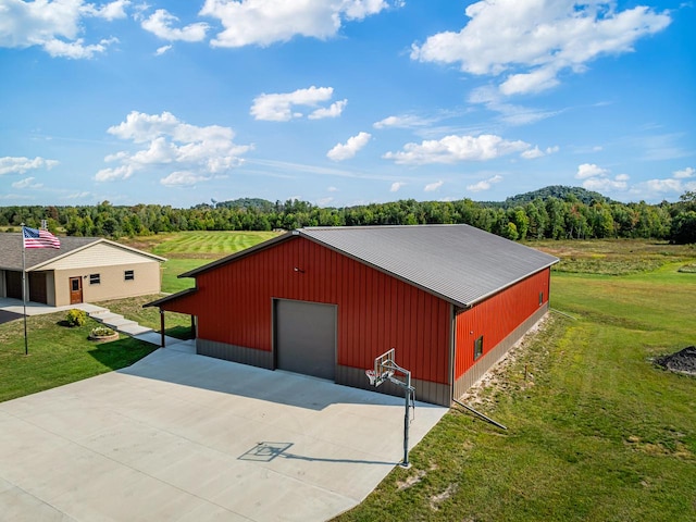 view of outdoor structure with a yard and a garage