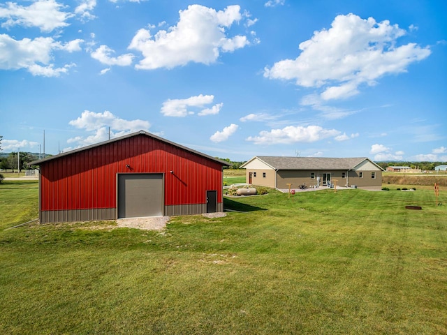 view of outdoor structure with a yard and a garage