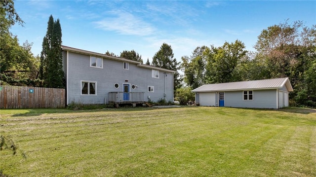 back of house with a lawn and fence