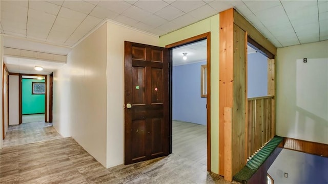 corridor featuring ornamental molding and wood finished floors