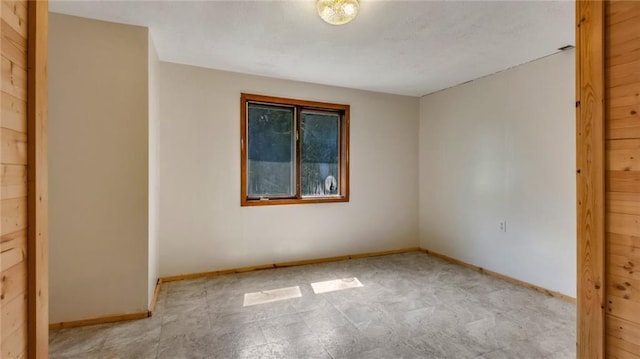 spare room featuring baseboards