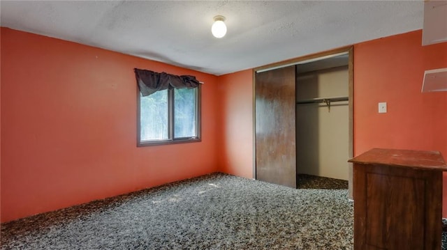 unfurnished bedroom featuring a closet and carpet