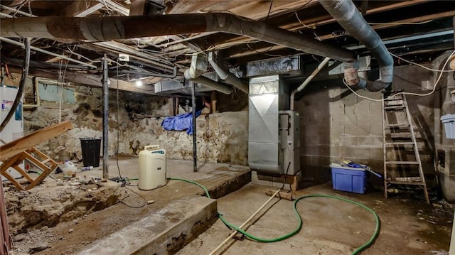 unfinished basement featuring heating unit