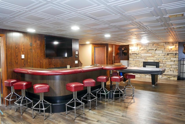 bar featuring a fireplace and dark wood-type flooring