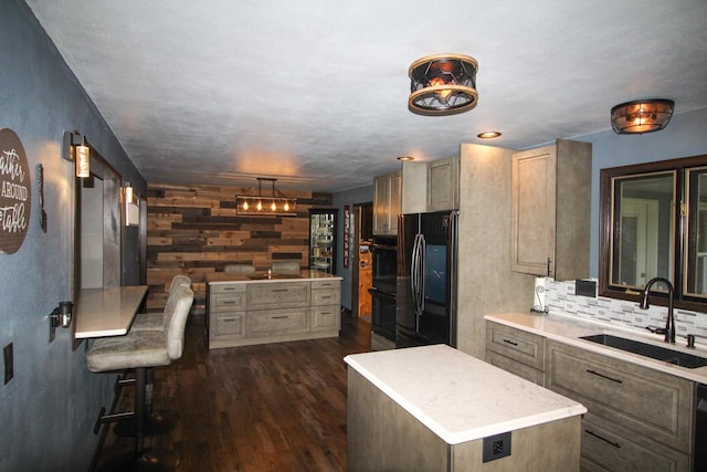 kitchen featuring dark hardwood / wood-style floors, black appliances, tasteful backsplash, a center island, and sink