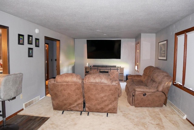 carpeted living room with a textured ceiling