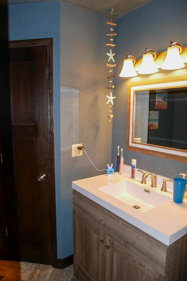 bathroom with hardwood / wood-style floors and vanity