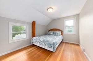 bedroom featuring vaulted ceiling and hardwood / wood-style floors