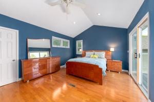 bedroom featuring hardwood / wood-style floors, ceiling fan, and vaulted ceiling