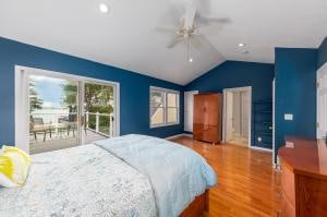 bedroom featuring lofted ceiling, access to exterior, ceiling fan, and hardwood / wood-style floors