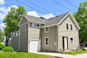 rear view of property with a garage