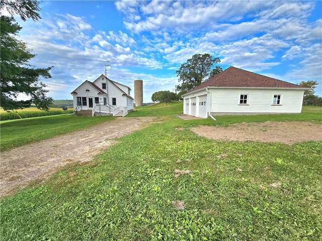 view of home's exterior with a yard and a garage