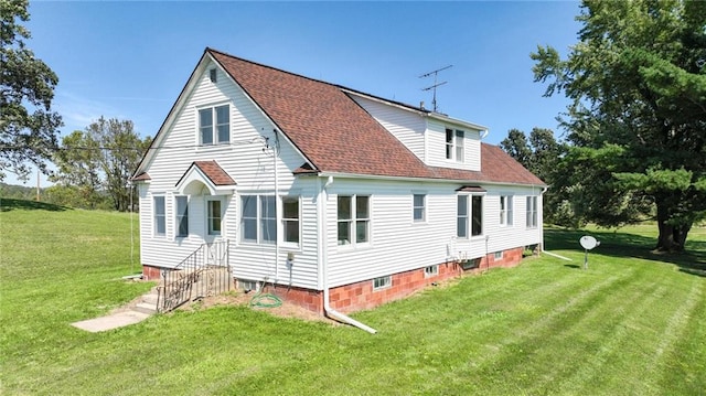 rear view of property featuring a yard