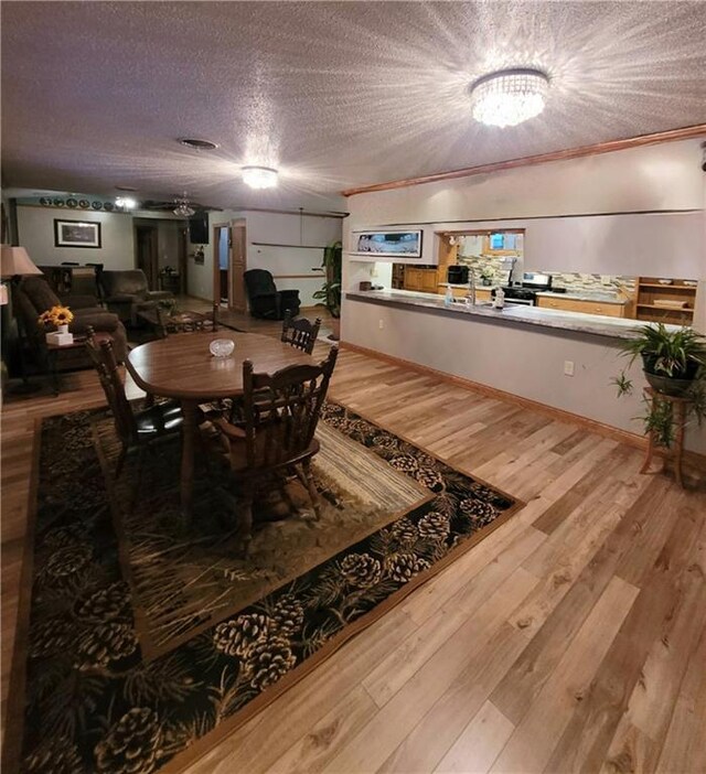 foyer entrance with a textured ceiling, crown molding, and hardwood / wood-style floors