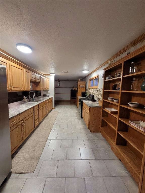 bathroom featuring tile patterned floors, a shower with door, a textured ceiling, and vanity