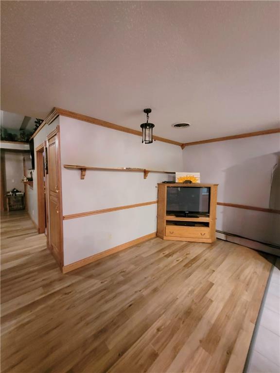 kitchen featuring light tile patterned floors, a textured ceiling, sink, and light stone countertops