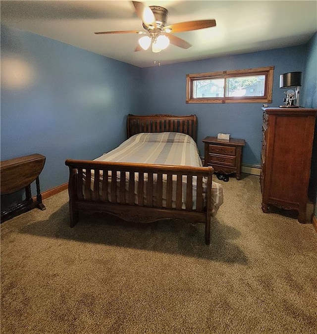 carpeted bedroom featuring baseboard heating and ceiling fan