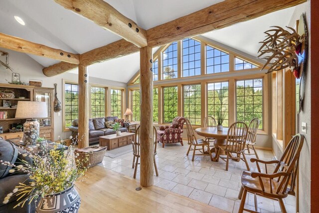 sunroom / solarium with lofted ceiling with beams