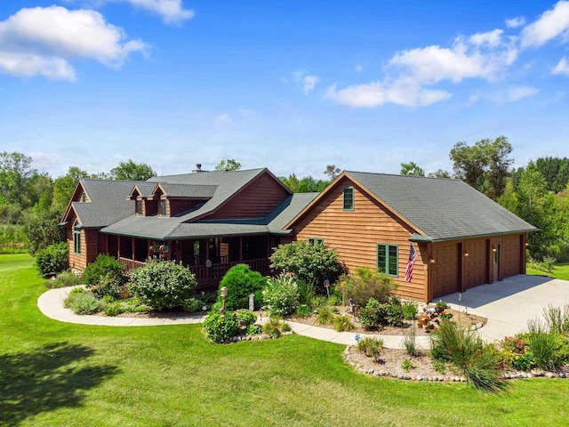 view of front of property featuring a front lawn, a garage, covered porch, and driveway