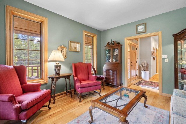 sitting room featuring baseboards and wood finished floors