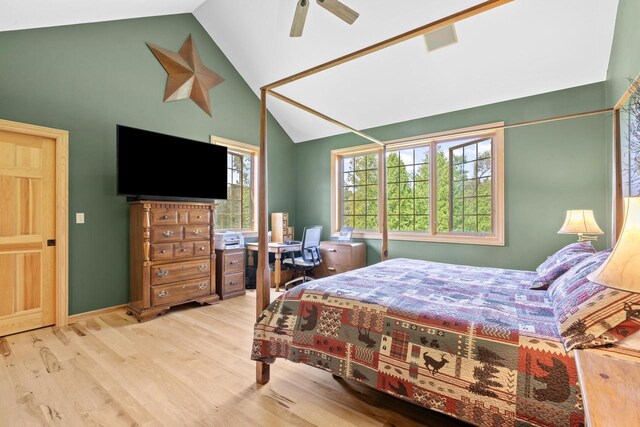 bedroom featuring visible vents, a ceiling fan, lofted ceiling, and wood finished floors