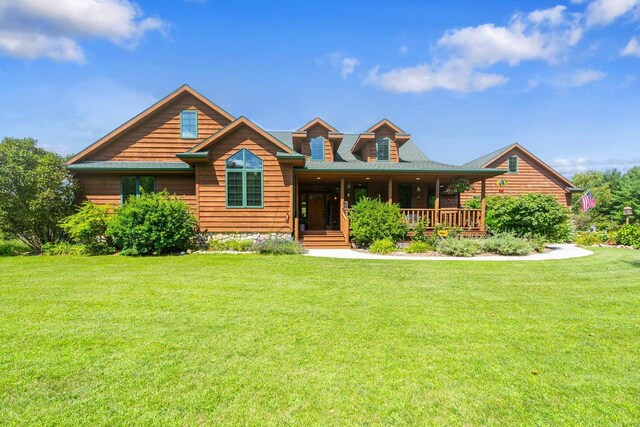 log home with a front yard and covered porch