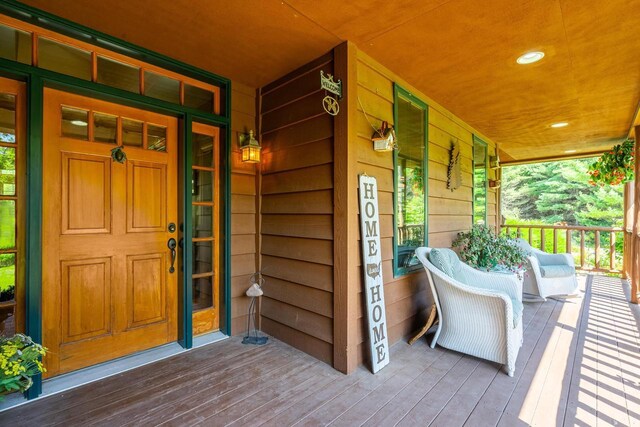 view of exterior entry with covered porch