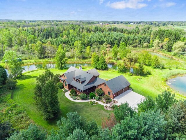 bird's eye view with a view of trees and a water view