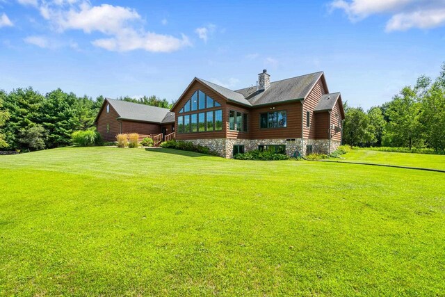 back of house with a lawn and a chimney