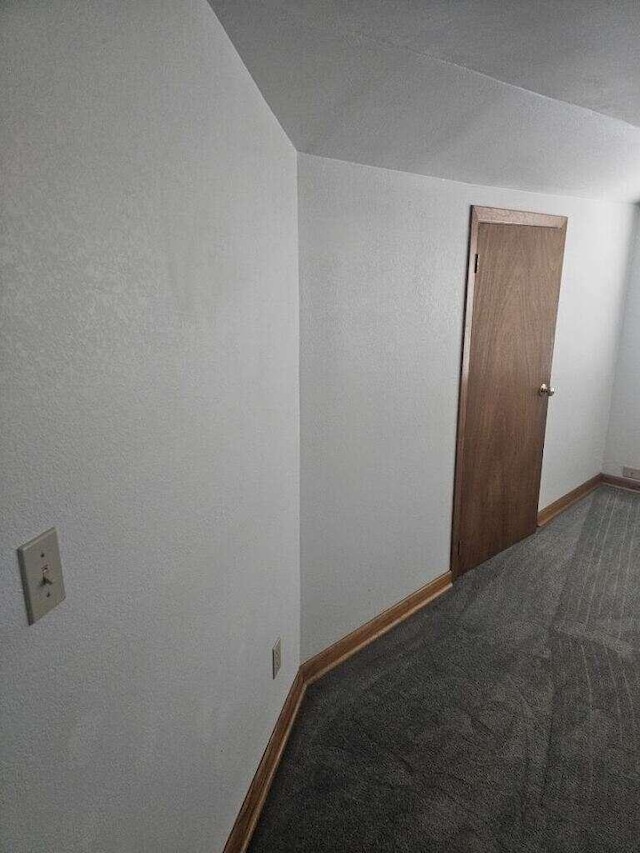 unfurnished room with baseboards and carpet floors