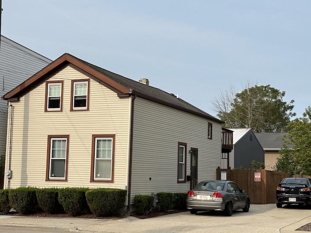 view of home's exterior with fence