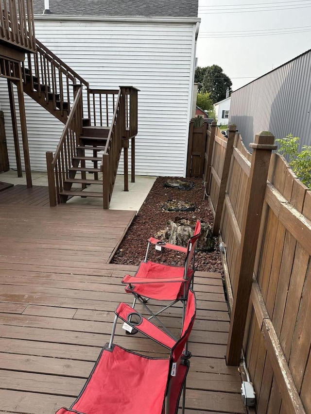 wooden deck featuring stairway and a fenced backyard