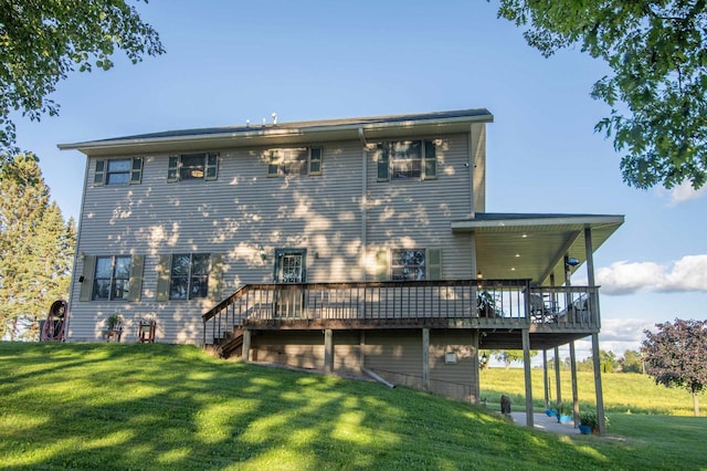 rear view of house featuring a yard and a deck