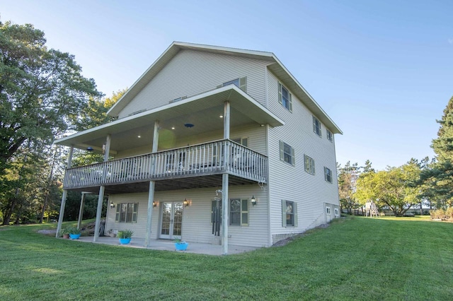 back of property with a patio area and a yard