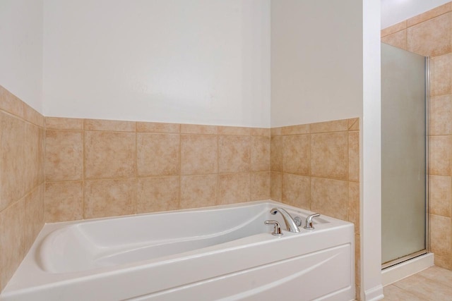 bathroom with independent shower and bath and tile patterned floors