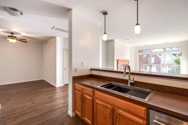 kitchen with pendant lighting, dark hardwood / wood-style flooring, sink, ceiling fan, and stainless steel dishwasher