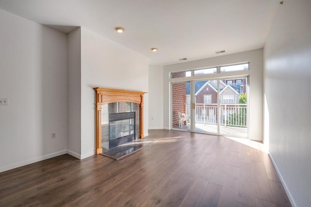 unfurnished living room featuring a fireplace and dark hardwood / wood-style flooring