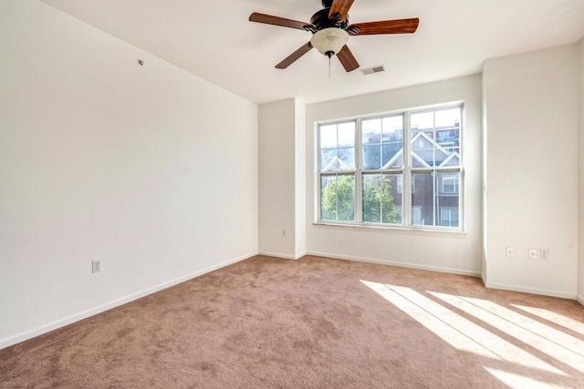 unfurnished room featuring ceiling fan and light carpet